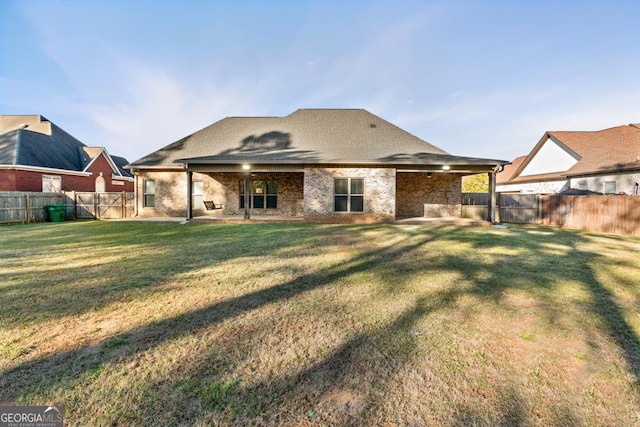 back of house with a yard