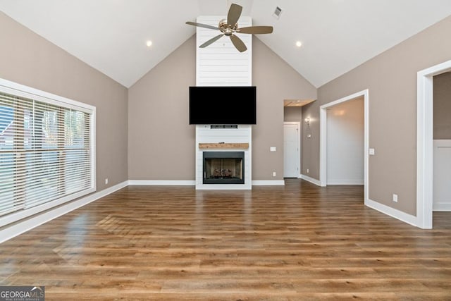 unfurnished living room featuring ceiling fan, high vaulted ceiling, and wood-type flooring