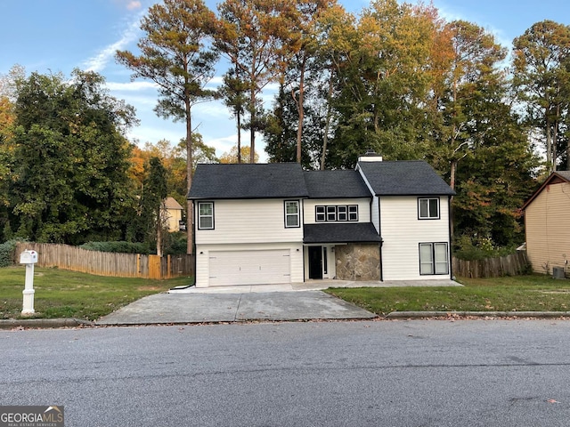 view of front of house with a front yard and a garage