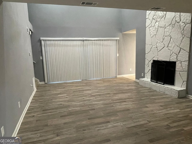 unfurnished living room with a fireplace and wood-type flooring