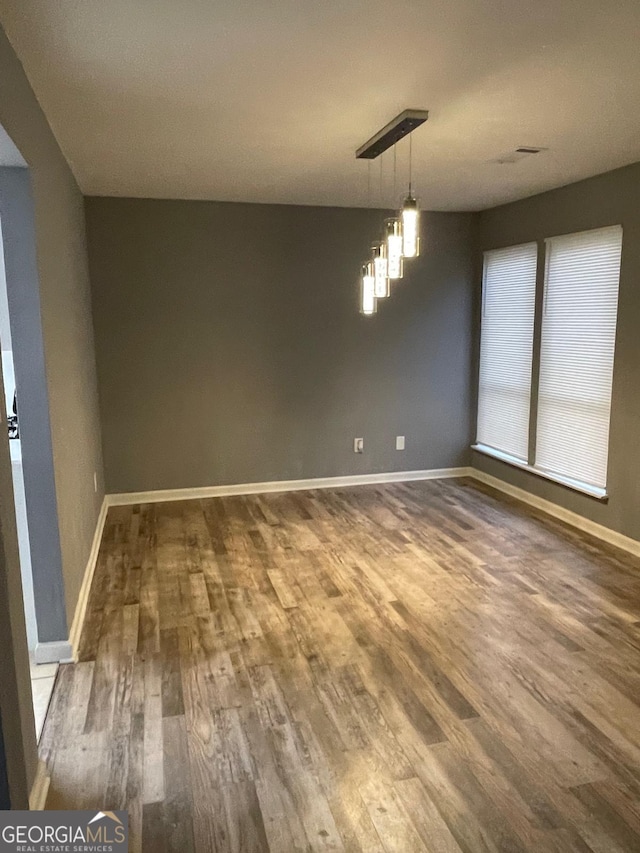 unfurnished room with hardwood / wood-style flooring