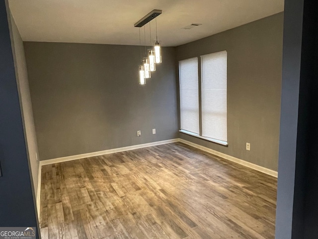 unfurnished room with wood-type flooring