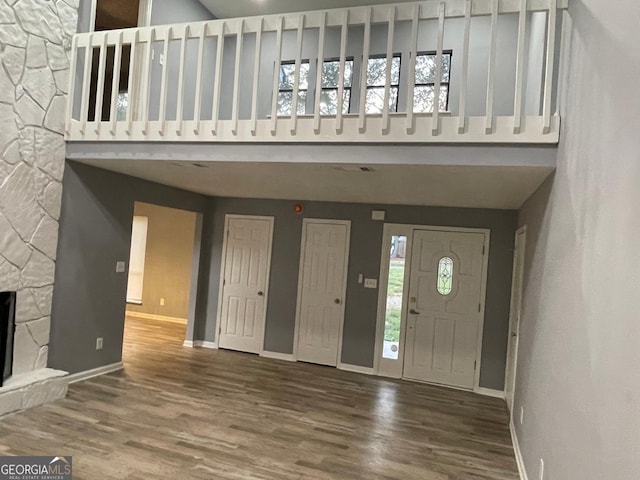 entryway with hardwood / wood-style flooring and a fireplace