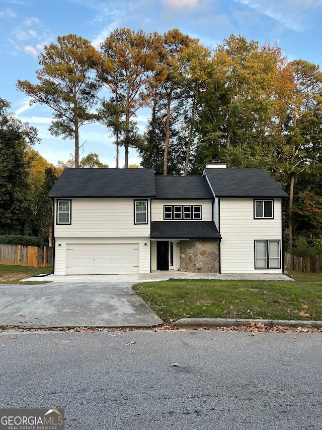 view of front of house with a front yard and a garage