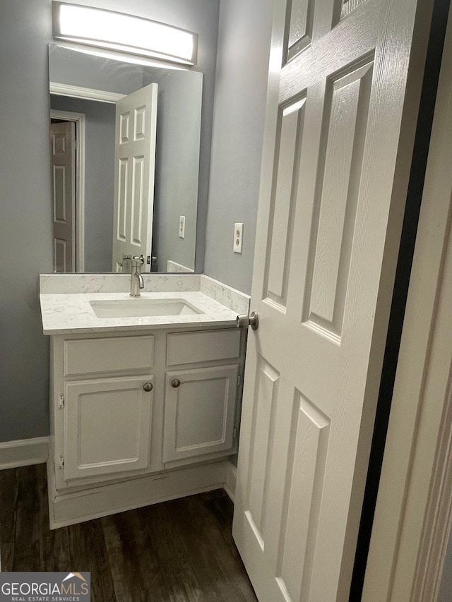 bathroom with vanity and hardwood / wood-style flooring