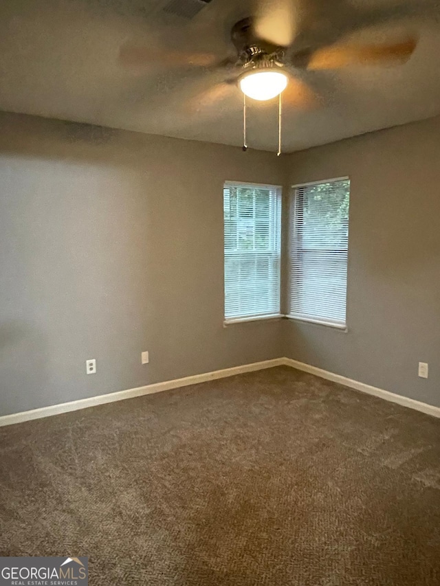 spare room with carpet and ceiling fan