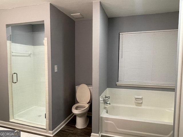 bathroom featuring hardwood / wood-style floors, toilet, and plus walk in shower