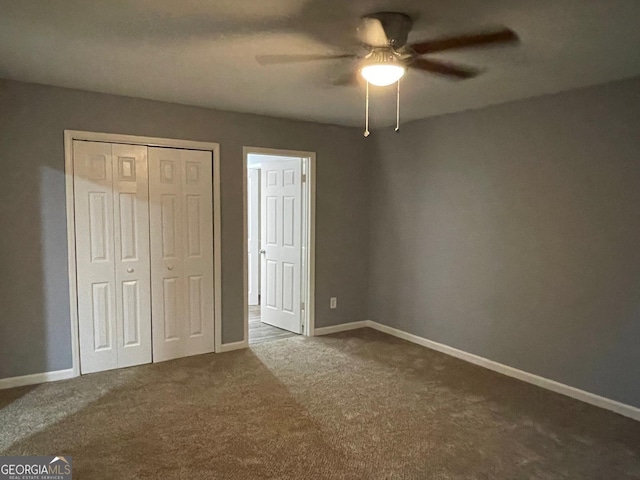 unfurnished bedroom featuring ceiling fan, a closet, and carpet floors