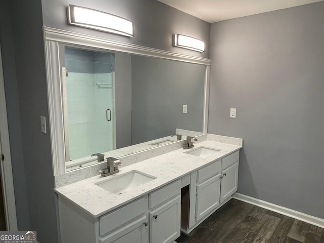 bathroom with vanity, wood-type flooring, and walk in shower