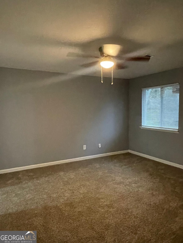 spare room with carpet flooring and ceiling fan