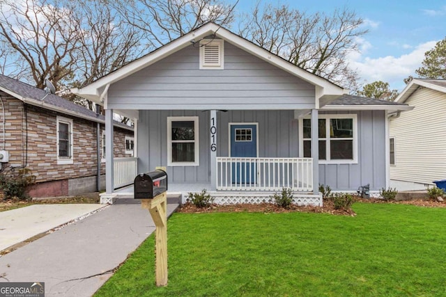 view of front of property with a porch and a front yard