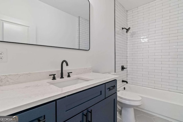 full bathroom with vanity, tiled shower / bath combo, tile patterned floors, and toilet