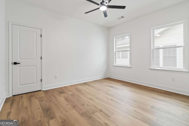 empty room featuring ceiling fan and light hardwood / wood-style floors