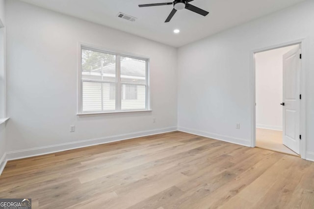 spare room with light hardwood / wood-style floors and ceiling fan