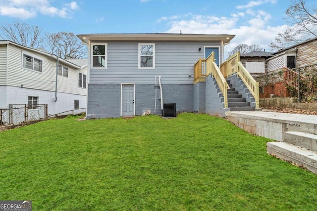 back of house with a yard and central AC unit