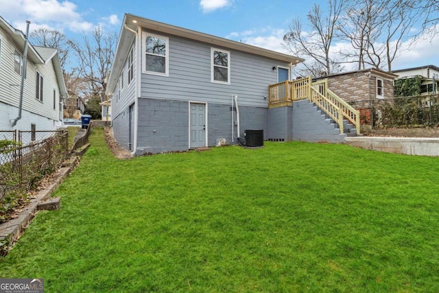 back of house featuring a yard and central AC unit