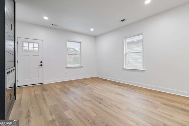 foyer entrance featuring light wood-type flooring and a wealth of natural light