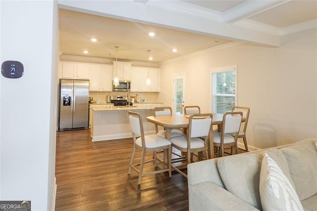 dining space featuring beam ceiling, ornamental molding, and dark wood-type flooring