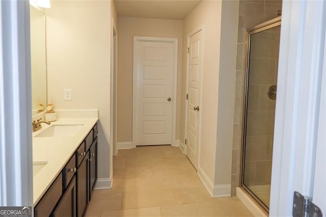 bathroom with tile patterned floors, vanity, and an enclosed shower