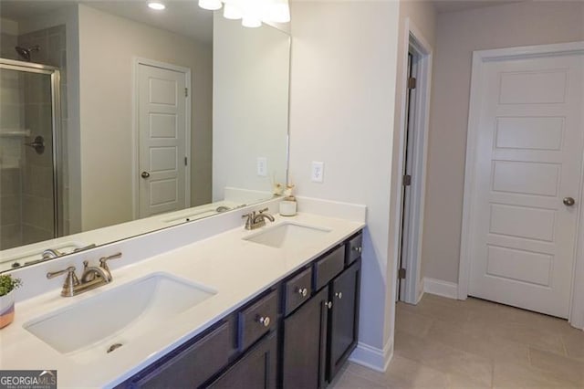 bathroom featuring tile patterned flooring, vanity, and walk in shower