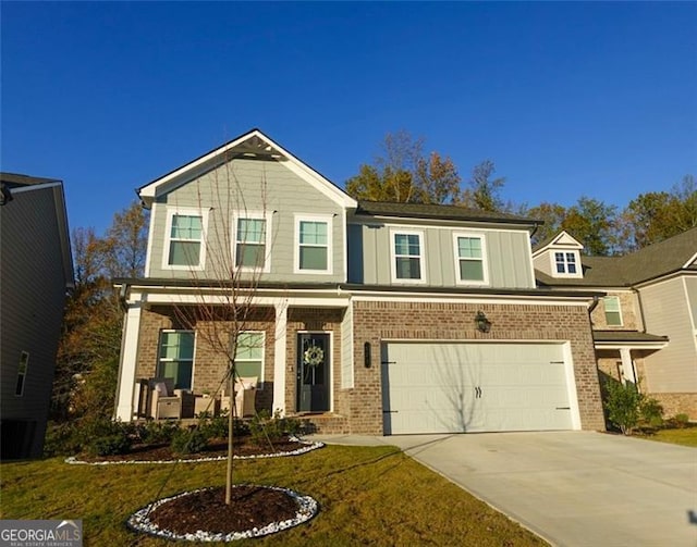 view of front of home with a front yard and a garage