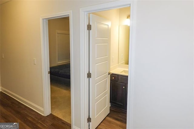 hallway with dark hardwood / wood-style flooring