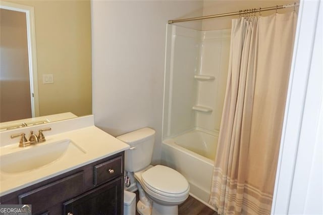 full bathroom with hardwood / wood-style flooring, shower / tub combo with curtain, vanity, and toilet