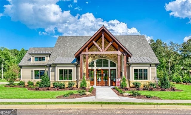 view of front facade featuring a front yard and french doors