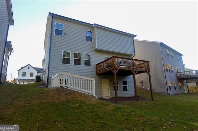 back of property with a yard, cooling unit, and a wooden deck