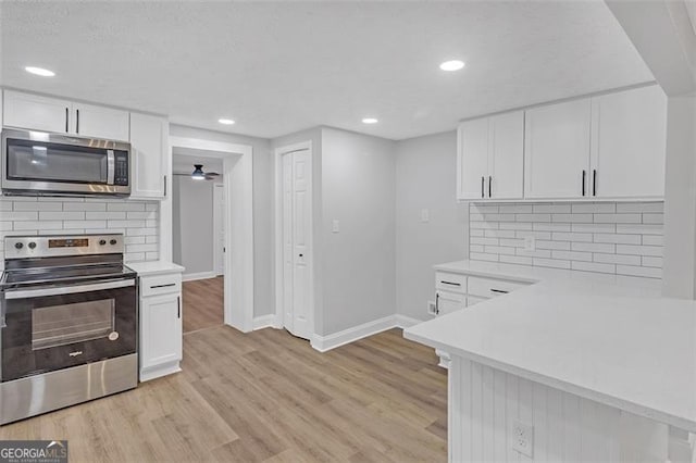 kitchen with tasteful backsplash, white cabinetry, and stainless steel appliances