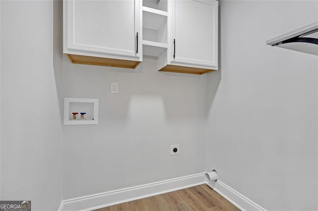 clothes washing area featuring cabinets, hookup for a washing machine, light wood-type flooring, and electric dryer hookup