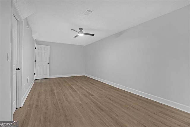 spare room featuring ceiling fan and wood-type flooring