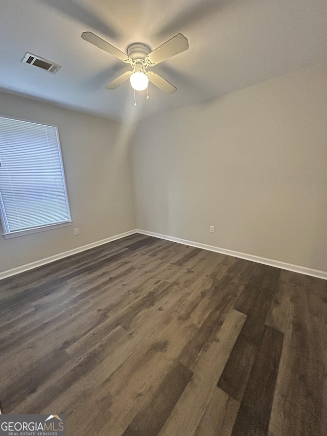 unfurnished room featuring ceiling fan and dark wood-type flooring