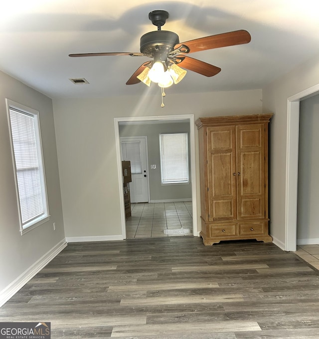 spare room featuring ceiling fan and dark wood-type flooring