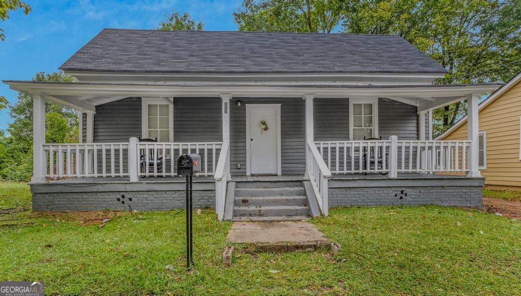 view of front facade featuring a front lawn and covered porch