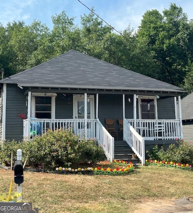 bungalow-style home featuring a porch and a front lawn