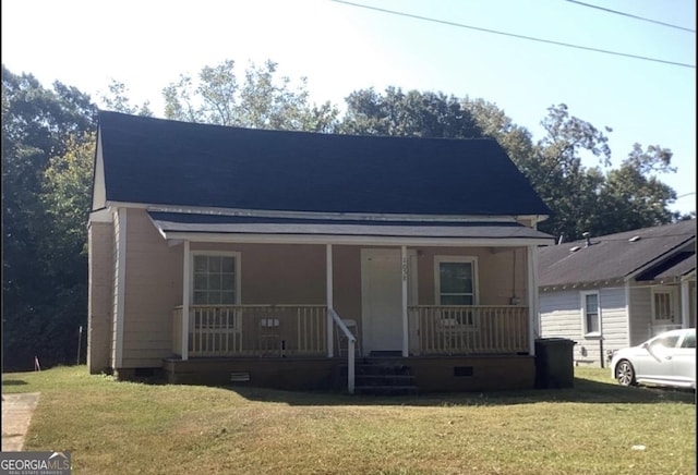 view of front of home with covered porch and a front yard