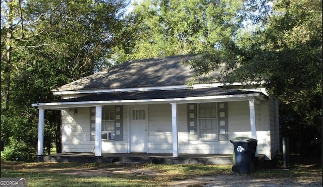 view of front facade with a porch and cooling unit