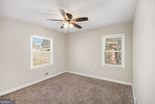 empty room with carpet flooring and ceiling fan