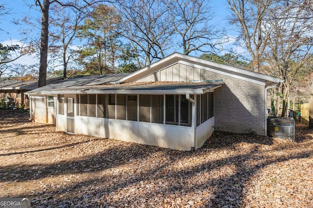 view of property exterior featuring central AC unit and a sunroom