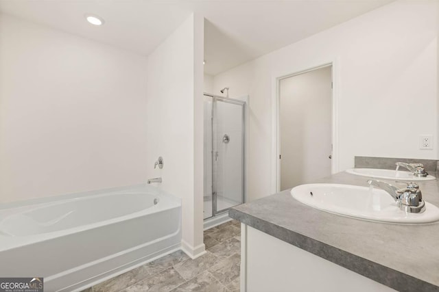 bathroom with vanity and independent shower and bath