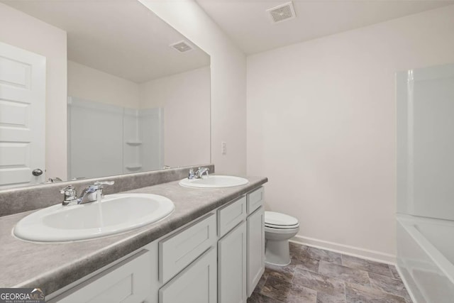 bathroom featuring a shower, vanity, and toilet