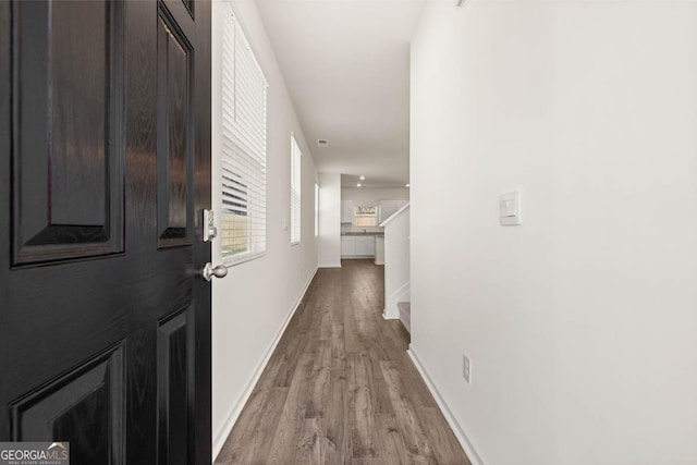 corridor with light hardwood / wood-style flooring