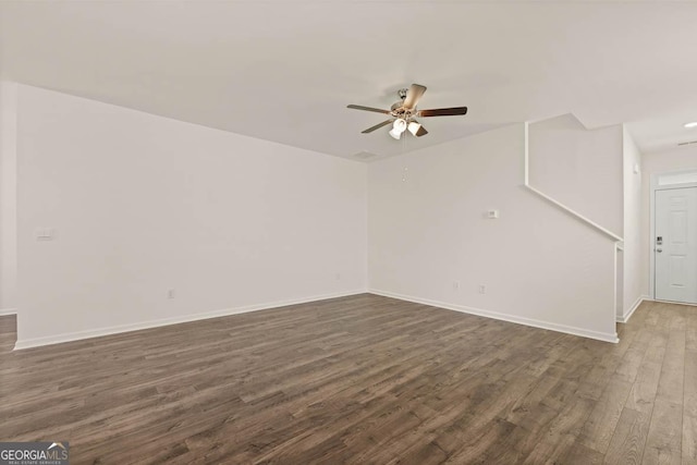 unfurnished room featuring ceiling fan and dark hardwood / wood-style flooring