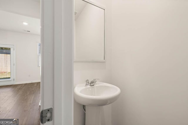 bathroom with hardwood / wood-style flooring