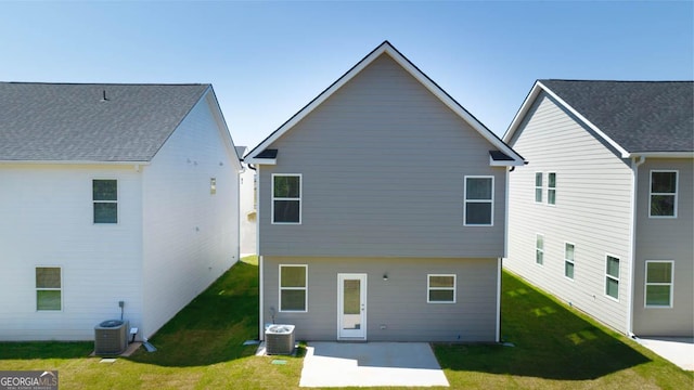 rear view of property featuring a lawn, a patio area, and central AC