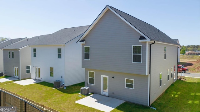 rear view of house featuring central AC, a yard, and a patio