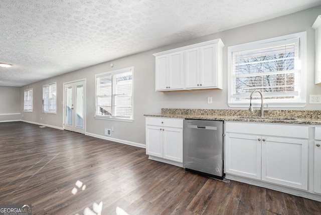 kitchen featuring dark wood-type flooring, sink, stainless steel dishwasher, stone countertops, and white cabinetry