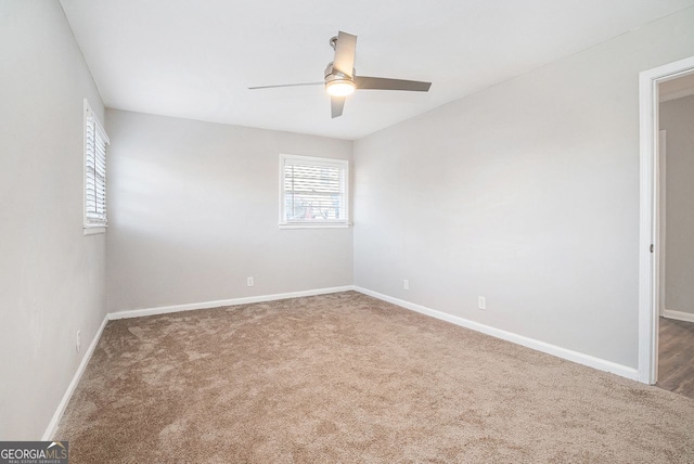 spare room with carpet floors and ceiling fan