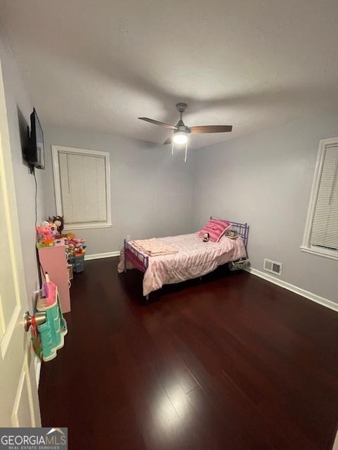 unfurnished bedroom featuring hardwood / wood-style flooring and ceiling fan